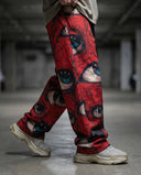 Ocular Crimson Wide Leg Trousers featuring bold graphic eyes design, worn in an urban setting.