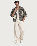 Fight Night Boxy-Fit Cuban Shirt worn open over a cream tank with cream pleated trousers