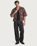 Masquerade Boxy-Fit Cuban Shirt worn open over a black tank with charcoal pleated trousers