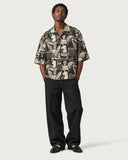 Renaissance Boxy-Fit Cuban Shirt buttoned with black baggy jeans