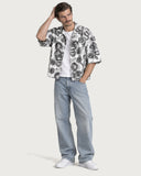 Tattoo Boxy-Fit Cuban Shirt worn open over a white tee with light-wash baggy denim