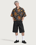 Rebellion Tiger Boxy-Fit Cuban Shirt buttoned with black denim shorts and loafers
